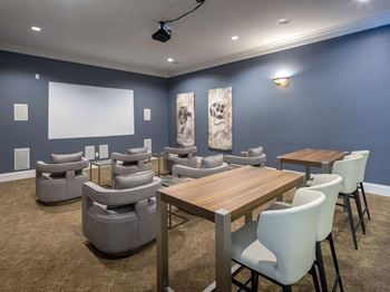 A conference room with a long table and chairs.